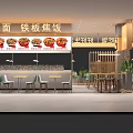 Modern Restaurant Interior With Warm Lighting Round Food Posters Green Plants And Tables