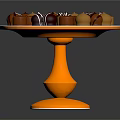 Assorted Chocolate Candies on Golden Pedestal Stand with Striped and Round Toppings