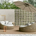 Outdoor Wicker Sofa with Curved Design Green Plants Umbrella and Cushions on Wooden Patio