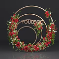 Elegant Circular Floral Installation with Golden Frame Red Flowers Green Foliage and Decorative Design
