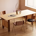 Wooden Dining Table With Four Mixed Design Chairs Vase Branches And Magazines Near Window