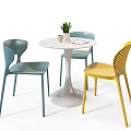 Modern Round Table and Chair Set with Blue Yellow Chairs White Cup and Potted Plant