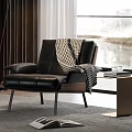 Black Leather Leisure Chair with Plaid Blanket and Side Table with Glasses Books by Window