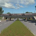 Road Infrastructure Featuring Multi lane Road Vehicles Railway Overpass Green Grass And Trees