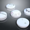 Multiple White Round Electronic Smoke Detectors With Indicator Lights For Home Safety