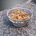 Crispy Cereal Flakes with Fresh Milk in Bowl on Granite Kitchen Countertop