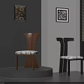 Two Brown And Black Wooden Chairs With Patterned Cushions Grey Wall Decorative Paintings Interior