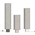 Three Modern Floor Lamps With Cylindrical Fabric Shades And Different Colored Bases