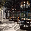 Chinese Style Restaurant Interior With Black Lattice Chandeliers Round Tables Patterned Carpet And Green Plants