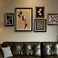 Decorative Photo Wall With Various Framed Artworks And Patterns Above Leather Sofa In Living Room