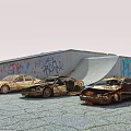 Three Rusty Abandoned Cars Parked In Front Of Graffiti Covered Building On Gravel Ground
