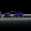 Blue Heavy Duty Utility Vehicle Transporting Excavator On Flatbed Trailer At Night
