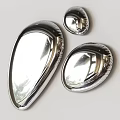 Three Shiny Metallic Shell Shaped Objects With Polished Reflective Surface On White Background