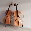 Two Wooden Cellos Leaning Against Wall With Bows In Indoor Setting