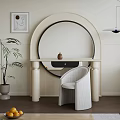 Modern Beige Dressing Table With Round Mirror Wicker Chair And Potted Plant