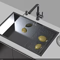 Black Kitchen Sink With Drying Rack Yellow Fruits And Faucet On Light Countertop