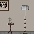 Vintage Floor Lamp With Scalloped Shade Near Side Table And Decorative Wall Art