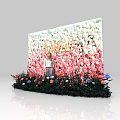 Colorful Floral Wall With VOGUE Lettering And Person Standing In Front