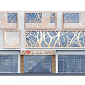 Modern Commercial Storefront With Glass Curtain Walls And Geometric Metal Frames In Urban Setting