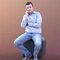 Man In Blue Shirt And Jeans Sitting On Chair With Crossed Arms Hand On Chin