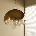 Gold Metal Shade Chandelier with Textured Clear Spherical Globes Near Window Blinds