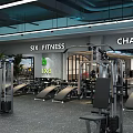 Modern Gym Interior Featuring Various Fitness Equipment Weight Machines Workout Benches and Bright Lighting