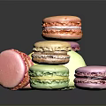 Colorful Macarons Stacked And Scattered On Dark Background With Vibrant Hues