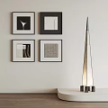 Four Modern Abstract Paintings With Black Frames On White Wall Near Floor Lamp