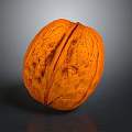 Close Up View Of Whole Brown Walnut With Textured Shell On Dark Background