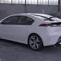 White Sedan With Modern Streamlined Design Large Alloy Wheels In Industrial Warehouse Setting