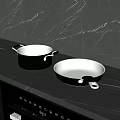 Sturdy Black Cooking Pots and Frying Pan on Sleek Marble Kitchen Counter