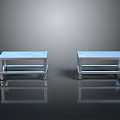 Two Light Blue Metal Frame Dining Tables with Wheels on Black Reflective Floor