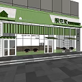 Shopping Mall Store Front With Green Awning Glass Windows And Decorative Plants