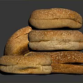 Golden Brown Sesame Seed Bagels Stacked and Single on Black Surface