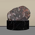Natural Red Brown Stone Displayed On Black Marble Base With White Veins
