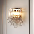 Modern Transparent Petal Design Wall Sconce With Gold Frame And Warm Lighting On White Wall