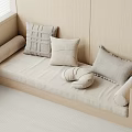 Light Gray And Beige Pillows With Various Textures On Beige Bench In Minimalist Cozy Interior