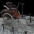 Vintage Tricycle With Wooden Seat Metal Frame And Large Wheels On Stone Pavement
