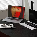 Two Laptops On Black Desk With Lit Screen Human Face Display And Black Screen Keys Notebook