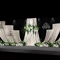 Modern Wedding Banquet Hall With White Curtains Floral Arrangements And Chandeliers On Stage