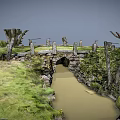 Rustic Stone Bridge Over Shallow Stream Surrounded By Green Grass And Trees 3d model