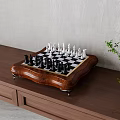 Classic Chess Set With Black And White Pieces On Wooden Cabinet For Indoor Entertainment