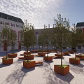 Campus Square Landscape Featuring Red Brick Buildings Wooden Planters Trees Benches and Paved Ground