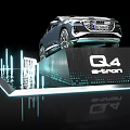 Audi Q4 e-tron Car on Display Platform with Illuminated Logo Blue Lighting and Water Reflection