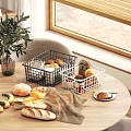 Cozy Wooden Round Dining Table With Chairs Near Window Side Bread Fruits And Metal Baskets