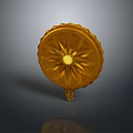 Golden Circular Clothing Accessory With Radiant Pattern And Carved Edges