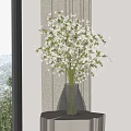 Stylish Geometric Glass Vase With White Small Flowers By Window With Curtains And Natural Light