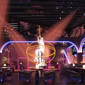 Modern Bar Interior with Neon Lights Sculpture Colorful Lighting and Seating Area