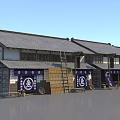 Traditional Japanese Wooden Buildings With Tile Roof Blue Banners White Symbols And Wooden Barrels