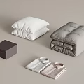 Cozy Bedding And Clothing Essentials With White Pillows Gray Quilt Dark Box And Folded Shirts